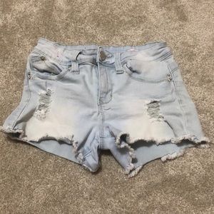 light blue denim shorts. low rise, distressed